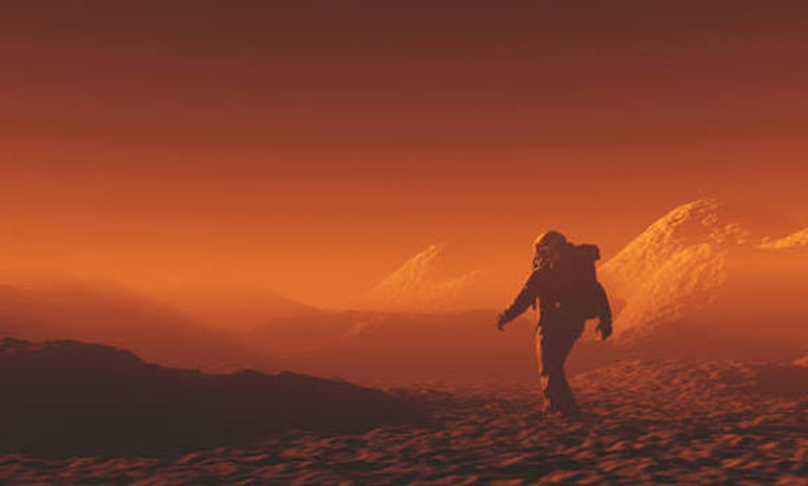 A lone suited figure walking across dunes under the orange haze of a Martian sky